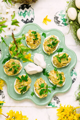 Easter deviled eggs with fried champignons on Easter background..top veiw