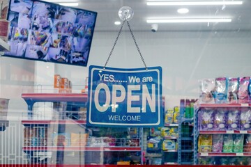 Open hanging sign board on a grocery store.