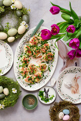 Eggs stuffed with bacon and green onions on Easter background..top veiw