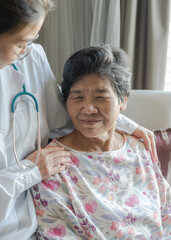 Elderly senior dementia patient (aged old adult person) in nursing hospice home with geriatrician...