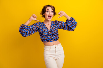Portrait of attractive lady in good mood screaming she is the best player pointing fingers herself...