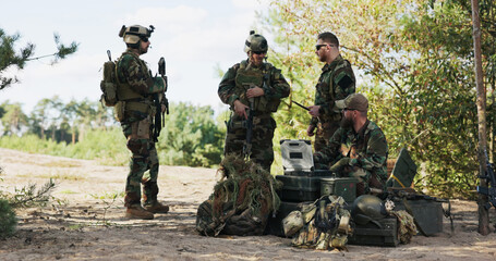 Soldiers set up details for today's mission, reviewing maps, entering tactical data on the...