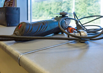 Angle grinder on a workbench, with other tools visible.