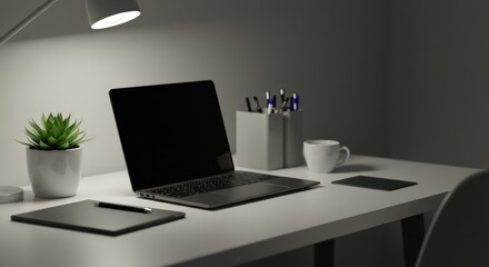 Laptop plant and desk lamp on a white desk against a gray wall.