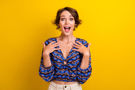 Photo of young funny girl shocked touch chest surprised amazed impressed reaction emotional person isolated on yellow color background