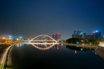 The glowing bridges and city skyline on the river at night, Chengdu, China