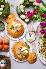 Traditional Polish Easter soup zurek served in a loaf of bread, smoked meats and egg..top veiw