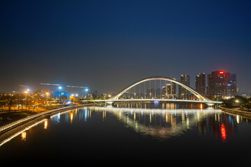 Naklejka premium The glowing bridges and city skyline on the river at night, Chengdu, China