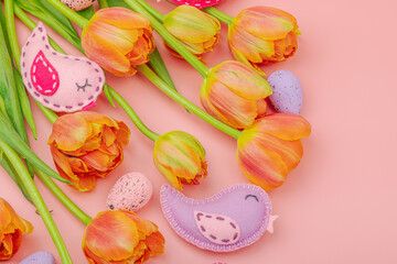 Gentle Easter composition with tulips flowers and handmade felt birds. Traditional elements