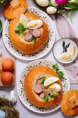 Traditional Polish Easter soup zurek served in a loaf of bread, smoked meats and egg..top veiw