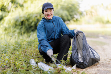 A local volunteer making a difference by picking up trash in a nearby public area.