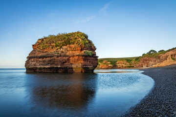 A sandstone sea stack at Ladram Bay near Sidmouth in South East Devon, captured at sunrise in July.