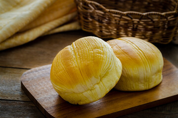 Fresh baked buns on wooden board