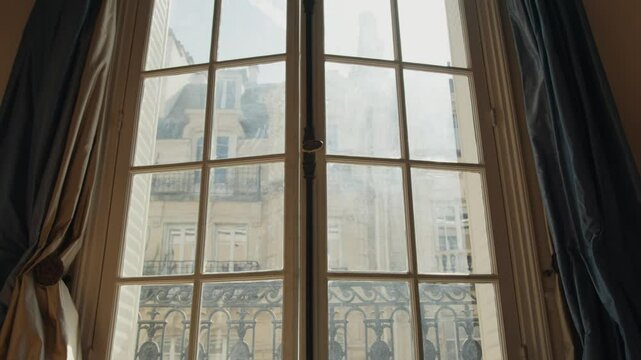 French window opening on parisian building