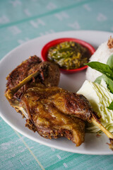 Indonesian fried duck, captured on April 16, 2025. Crispy on the outside and tender inside, served with rice, sambal, and fresh vegetables for a rich, savory meal