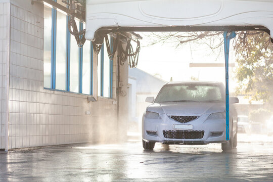 White car in automated car wash facility