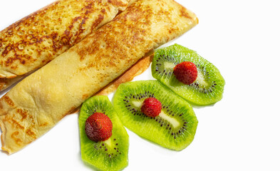 Thin pancakes, russian blini or french crepes with cottage cheese and kiwi. Tasty homemade breakfast