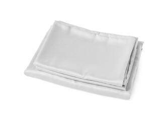 Stack of silky bed linens on white background
