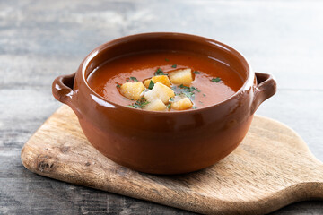 Traditional Spanish Gazpacho soup in bowl on wooden table