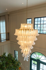 An elaborate, crystal chandelier in a hotel lobby or luxury home.