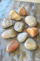 Obraz premium Smooth Colorful Stones on Wooden Surface Natural Background