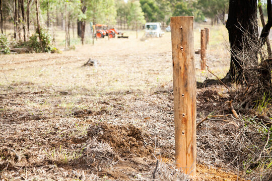 New post of farm boundary fence with holes drilled through it for the wire