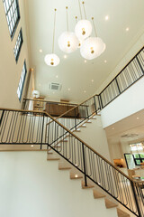 Home entrance hallway with modern chandelier and stairway leading to second floor.
