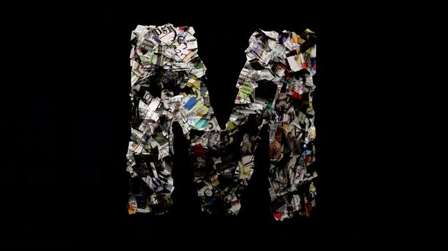 Letter M with cut up news paper isolated on black loop