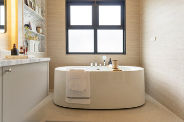 Bathroom interior, modern spacious white bathtub by the window.