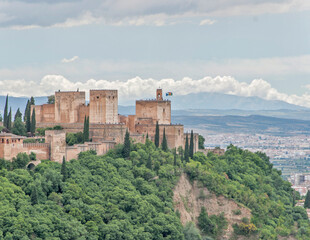 Fototapeta premium Alhambra palace complex on a hill overlooking a city, Granada, Spain