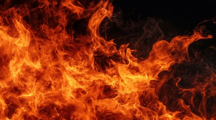 Intense flames dancing against a dark background, showcasing the power and beauty of fire. Perfect for illustrating heat and energy.