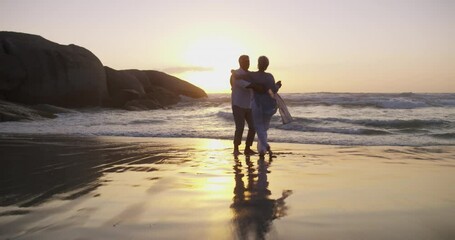 Happy couple, dancing on beach and fun in sunset and married on holiday, outdoor and retired. Retirement, elderly and love for commitment, bonding together and care for romantic relationship