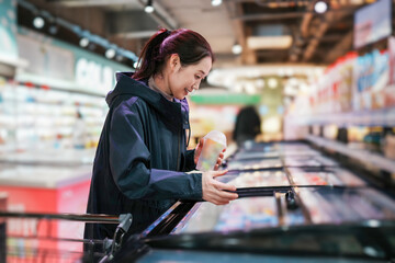 Woman Shopping in Grocery Store Frozen Food Aisle