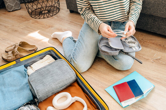 A suitcase packed with clothes, travel items and accessories representing preparation for a trip or vacation. Travel, organization and adventure planning concept