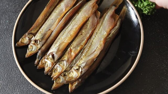 Fish smoked capelin sprat  dish fresh delicious gourmet food background on table rustic food top view copy space pescetarian diet
