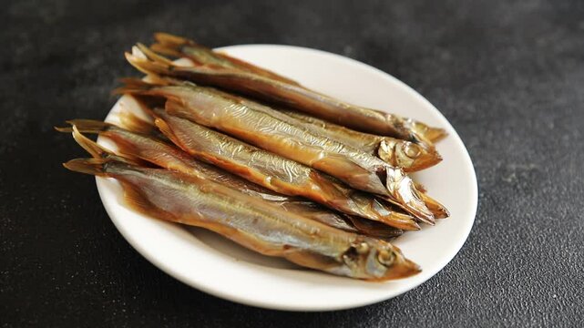 Fish smoked capelin sprat  dish fresh delicious gourmet food background on table rustic food top view copy space pescetarian diet