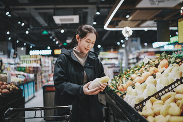 Woman Choosing Fresh Produce in Modern Grocery Store