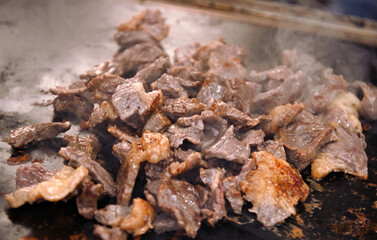 Sun-dried meat (Carne de sol) on the hot plate. Meat widely consumed in Brazil.
