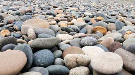 Stones of different sizes and colors but all with a rounded shape