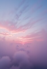 Fototapeta premium A breathtaking view of the sky at sunset, showcasing vibrant hues of orange, pink, and purple, with wispy clouds scattered across the horizon, creating a serene and picturesque atmosphere.