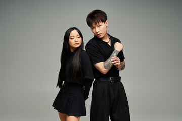 Stylish couple expressing love through fashion in an artistic indoor setting