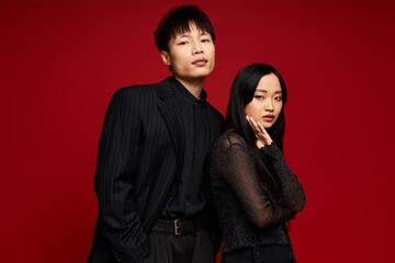 Stylish couple embodying romance with elegance against a vibrant backdrop