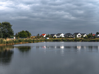 Obraz premium Residential houses near the lake at Owińska village, Poznań County, Greater Poland, Wielkopolska
