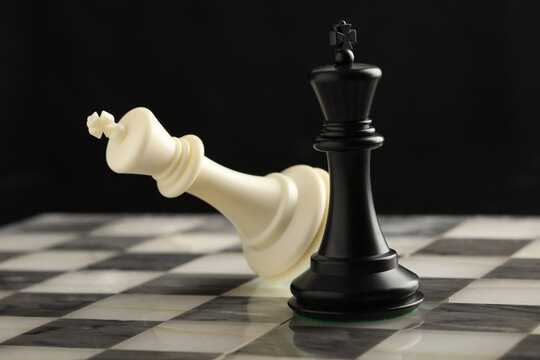 chess pieces on chessboard on marble background. game of chess - Powered by Adobe