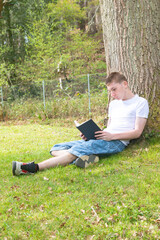 Teenage Boy Reading Outdoors