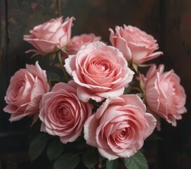 Obraz premium A vibrant bouquet of delicate pink roses, their soft petals unfurling gracefully, surrounded by lush green leaves, creating a stunning centerpiece that radiates beauty and elegance.