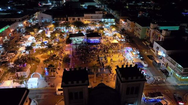 Panning and rotating aerial footage over the Parroquia San Antonio de Padua, of the celebrations and festivities in Isabela, Puerto Rico