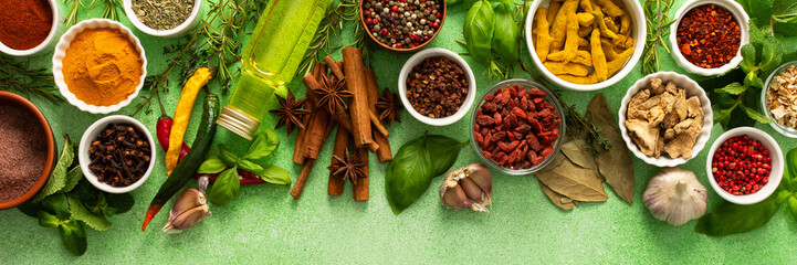 A beautiful collection of colorful spices and herbs, showcasing their natural aromas and vibrant hues on a gentle green background, top view , banner