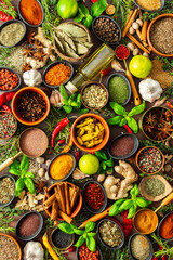 A colorful assortment of fragrant herbs and spices on a warm brown background, showcasing their visual variety and aromatic appeal