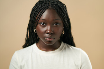 Young black woman posing with braided hair and white t-shirt